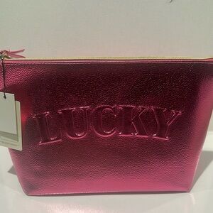 NWT Lucky Brand Travel Cosmetic bag with travel bottle.